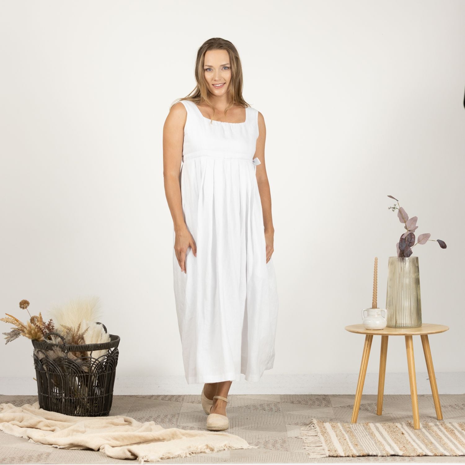 Front view of model wearing the Timeless Linen Summer Dress with wide straps, showcasing its mid-calf length and easy-to-wear design.