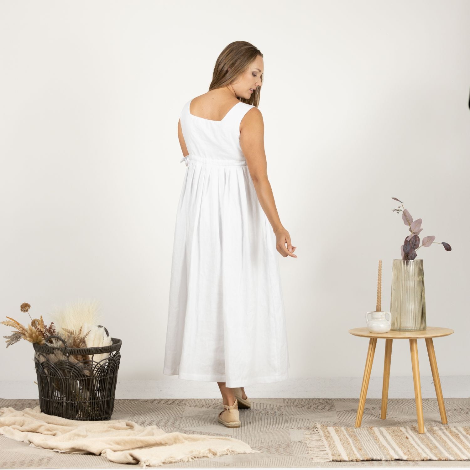 Rear perspective of the Timeless Linen Summer Dress with wide straps on model, highlighting the dress's simple and timeless design.