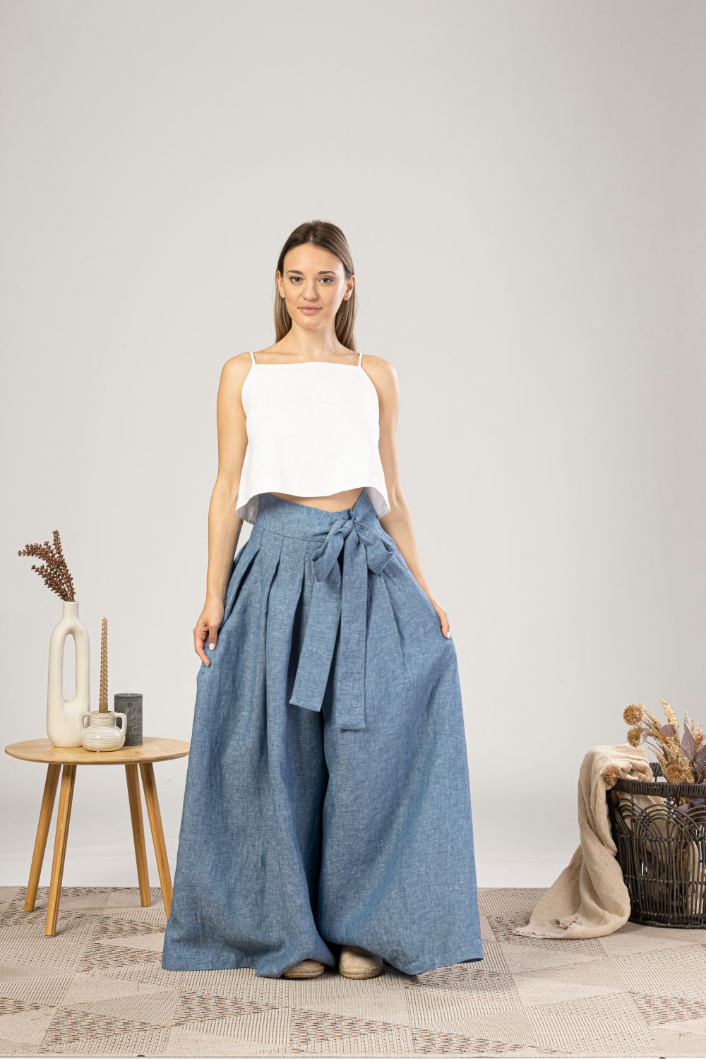 Summer capsule wardrobe: blue mélange wide-leg linen trousers with a white top, a mix-and-match natural-fabric outfit