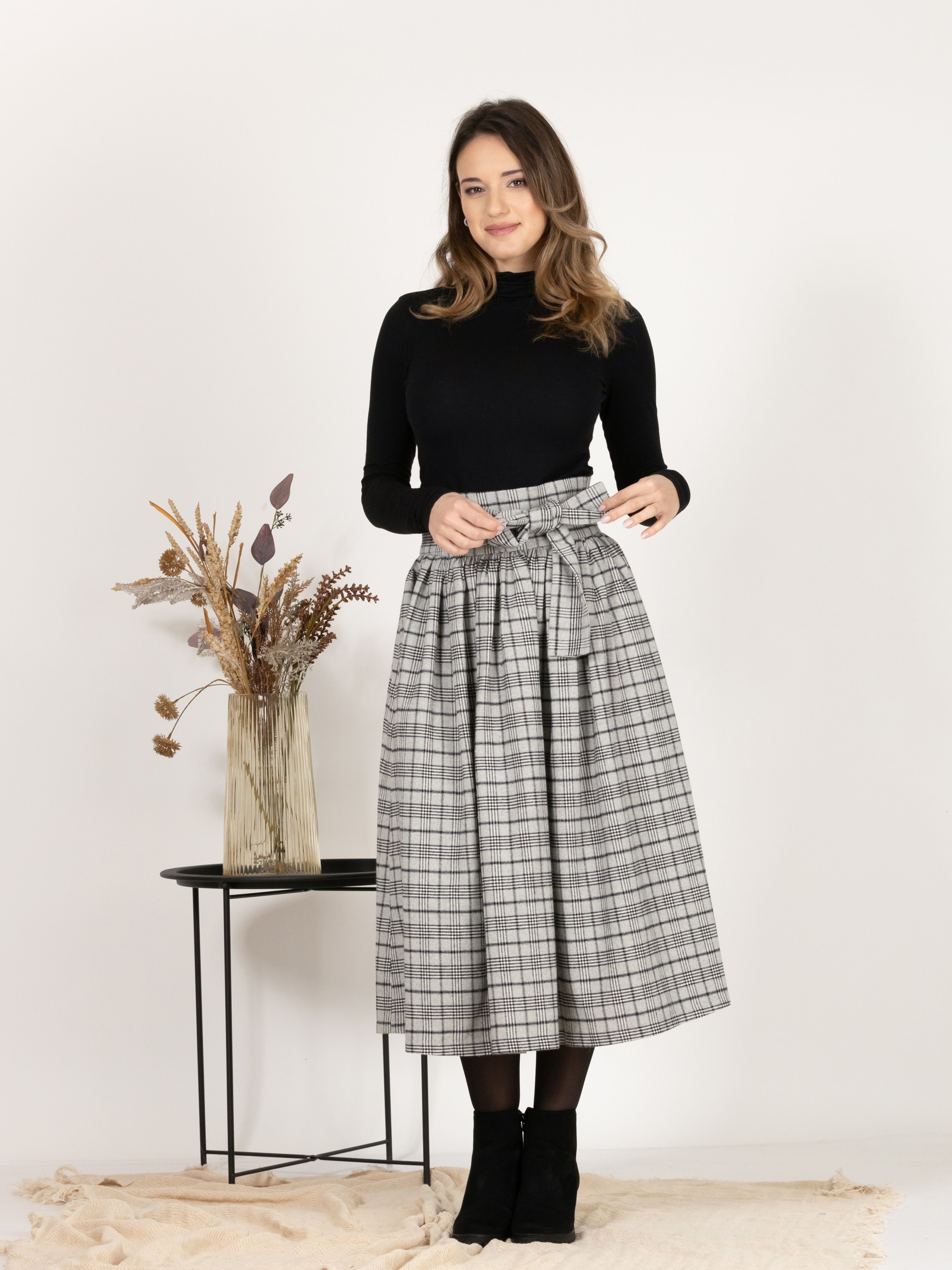 Front view of Wool Midi Plaid Skirt with High Waisted Bow and Pockets
highlighting the bow detail at the waist