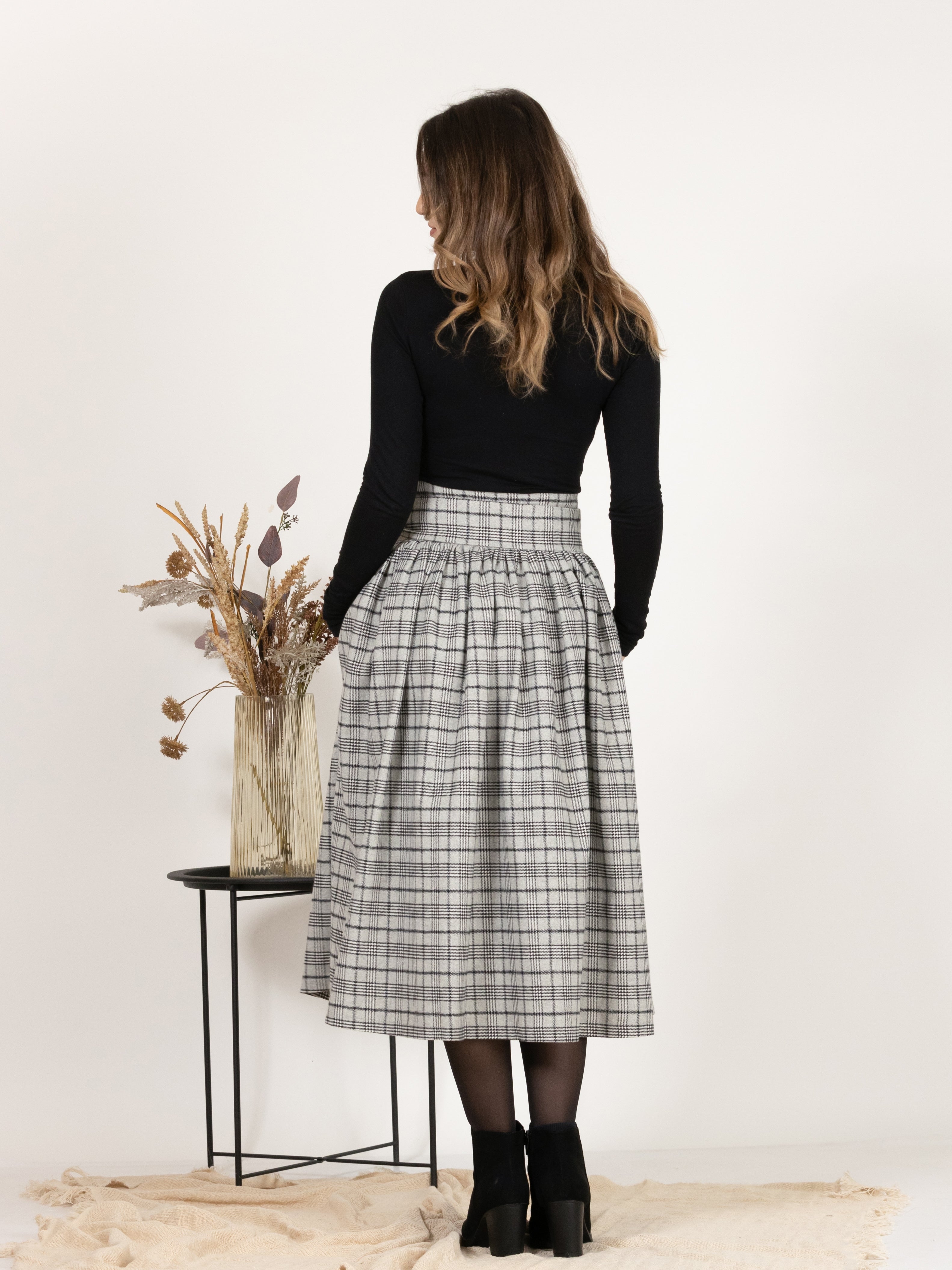 Back view of Wool Midi Plaid Skirt with High Waisted Bow and Pockets,
highlighting the midi length