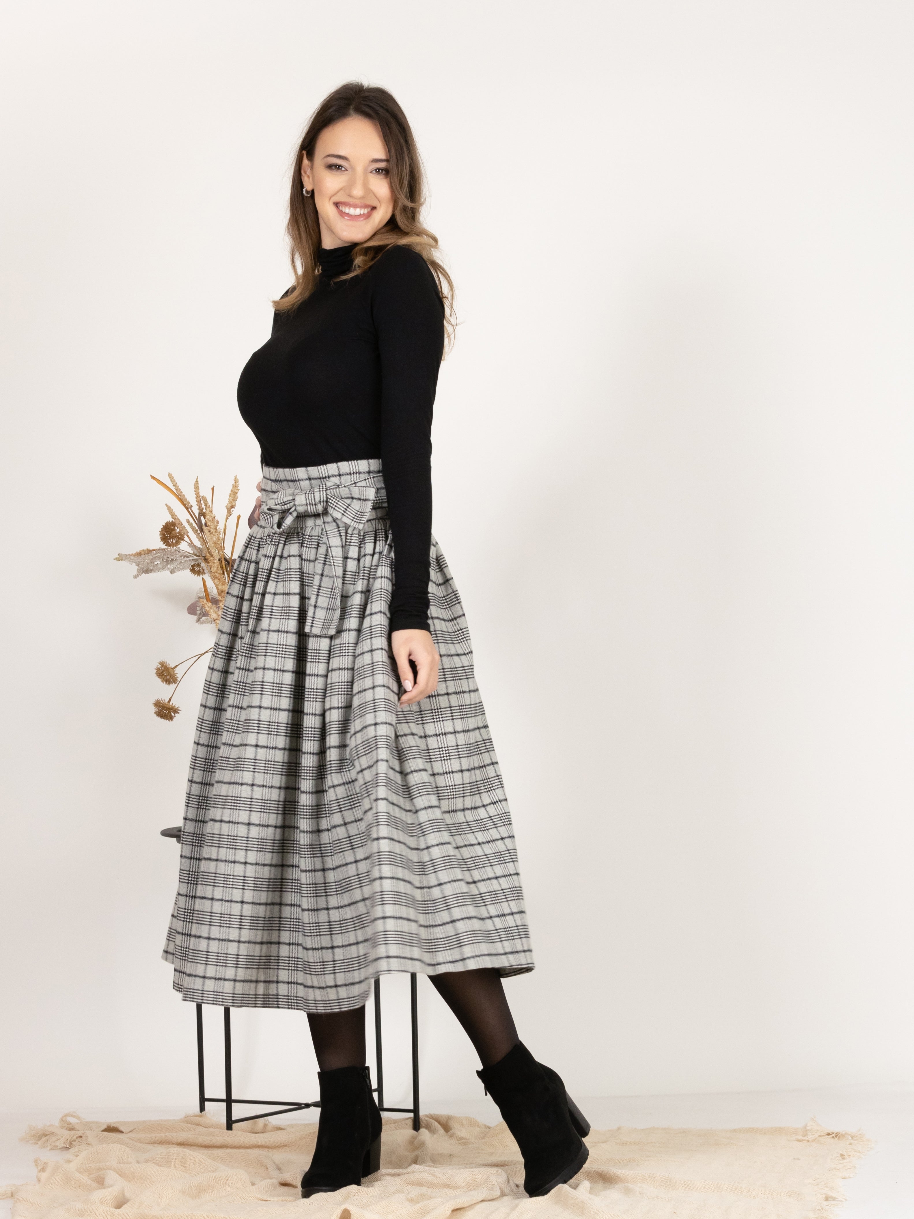 Side view of Wool Midi Plaid Skirt with High Waisted Bow and Pockets
highlighting high waist