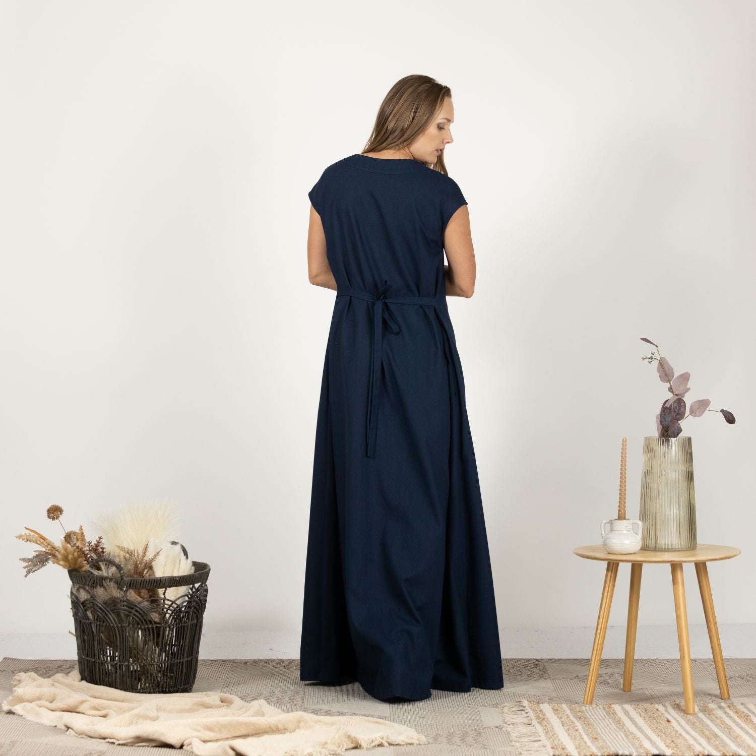 Model presenting the back of the Linen Loose Dress with Back Tie, emphasizing the dress's flattering fit and tie feature.