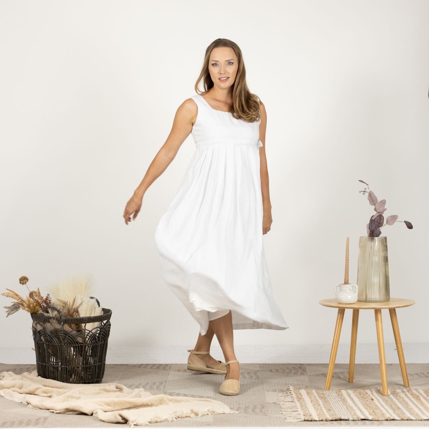 Model in the Timeless Linen Summer Dress with wide straps, side view capturing the dress's elegant lines and versatile style
