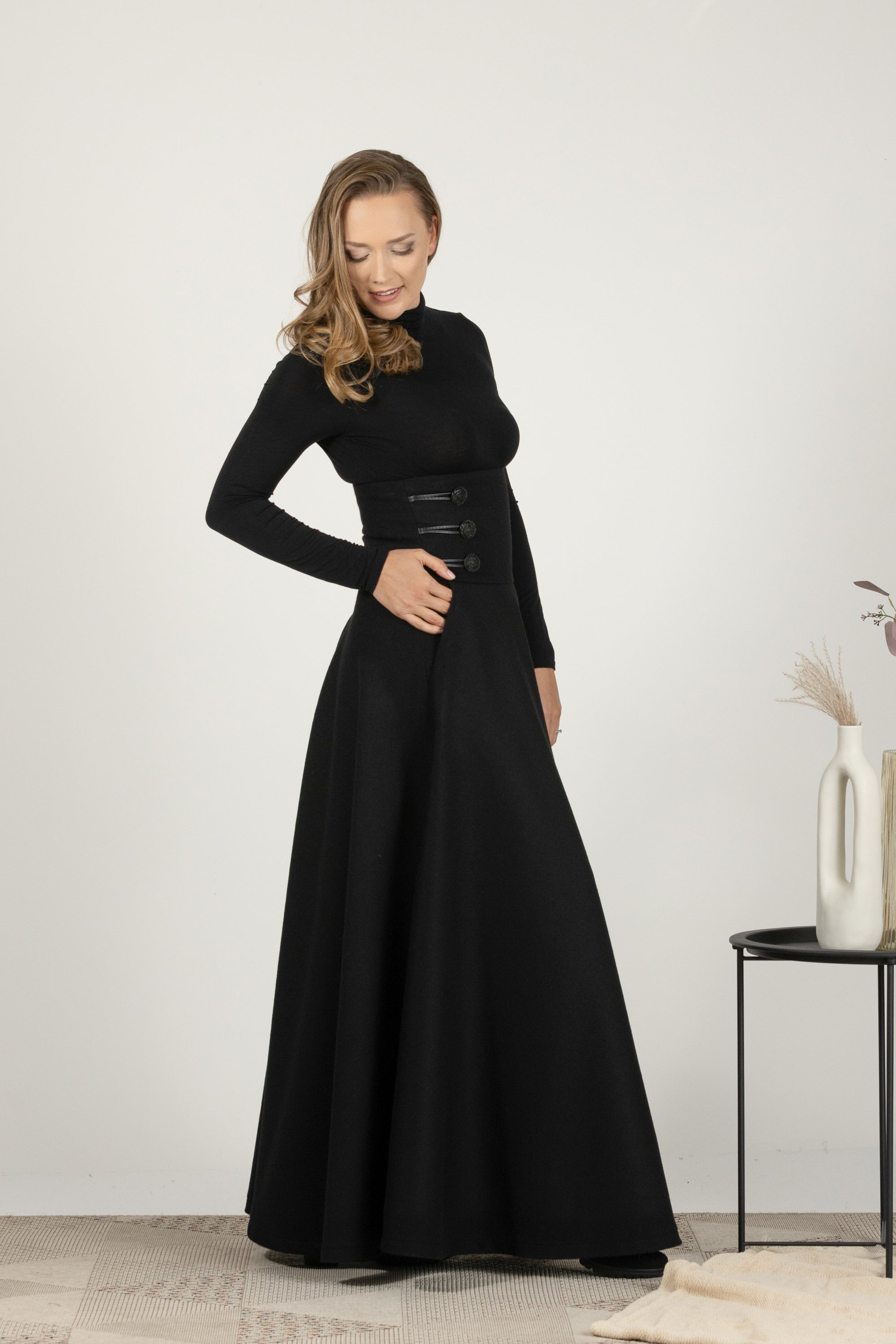 Side view of flared winter skirt in black wool with pockets
