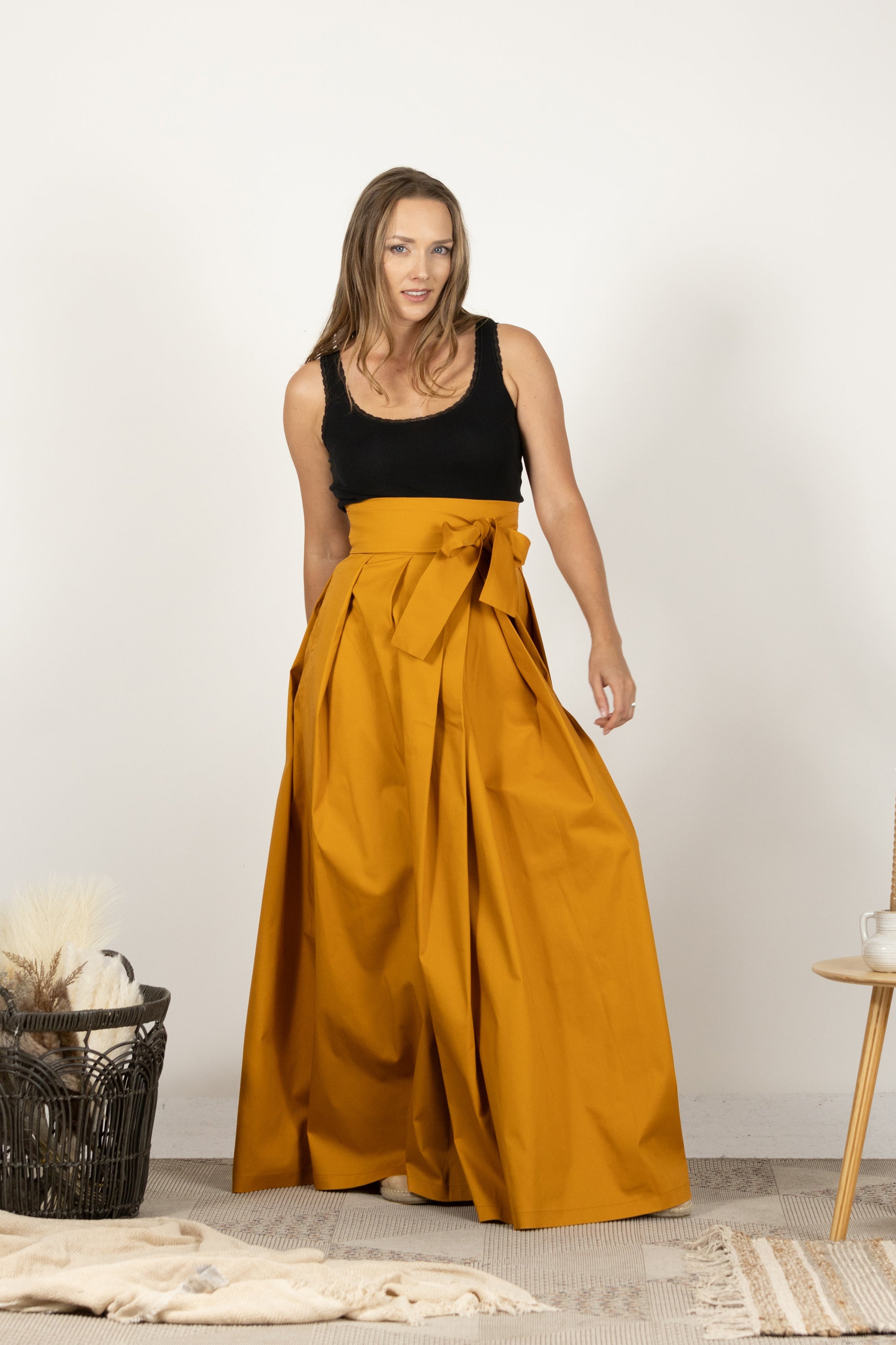 Pleated dark yellow skirt in full-length design