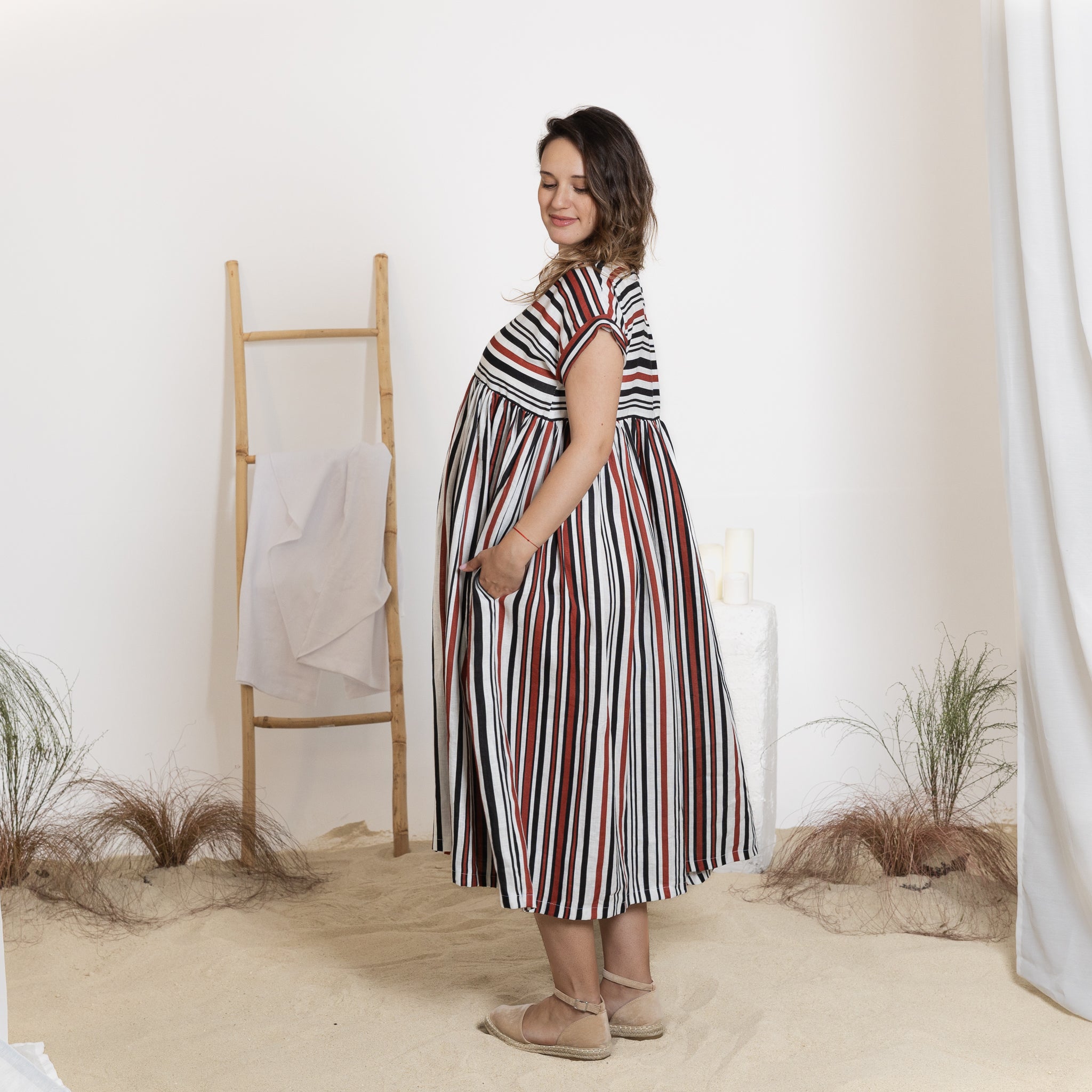 Side view of linen striped dress with pockets