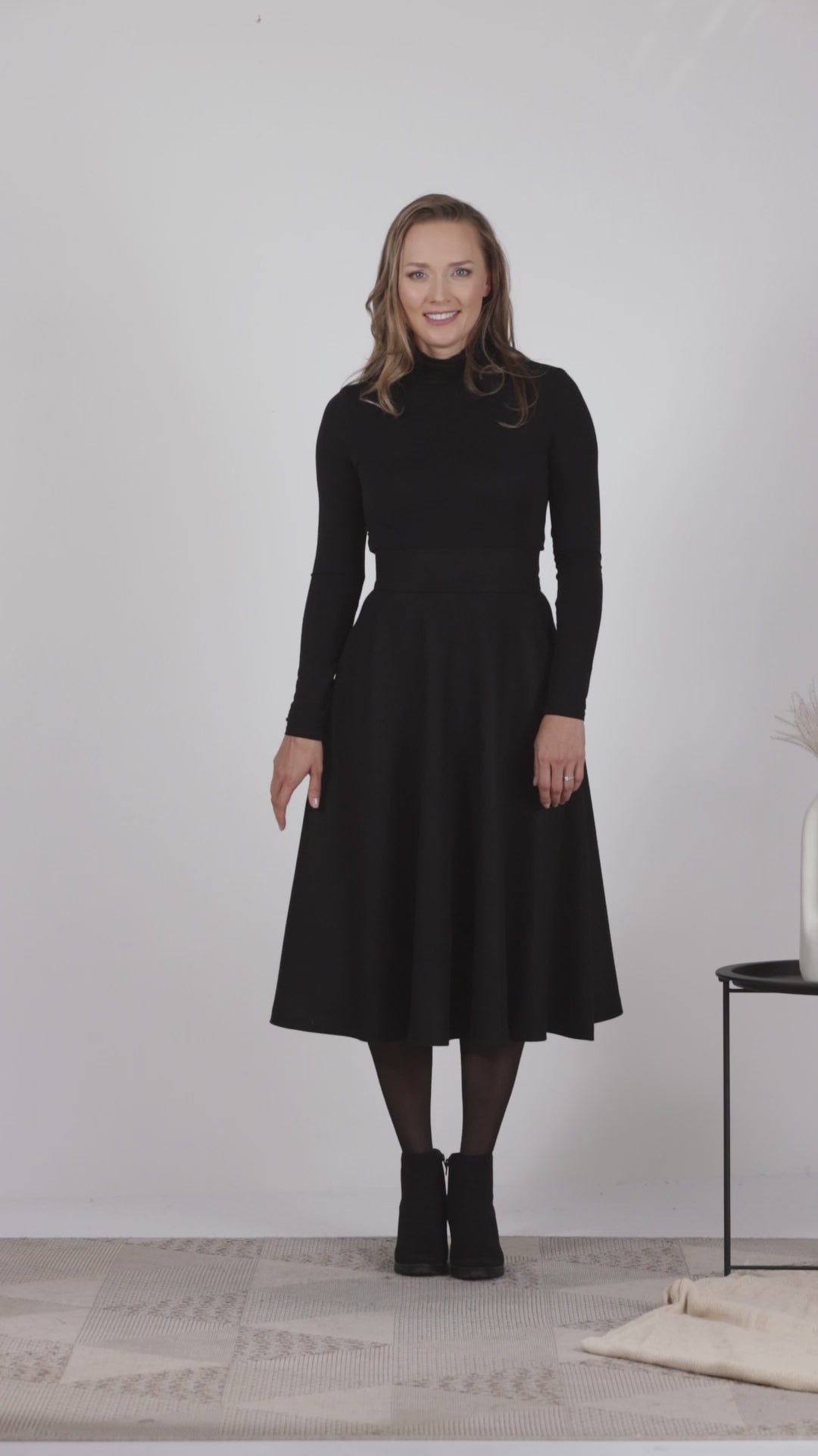 Full view of elegant black midi-length winter skirt